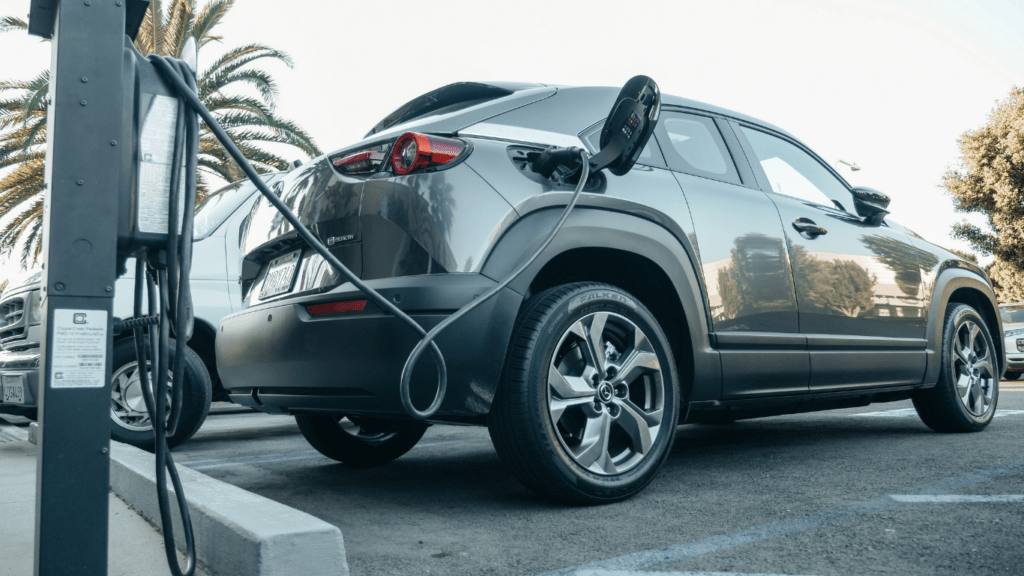 an electric vehicle is plugged into an electric charging station