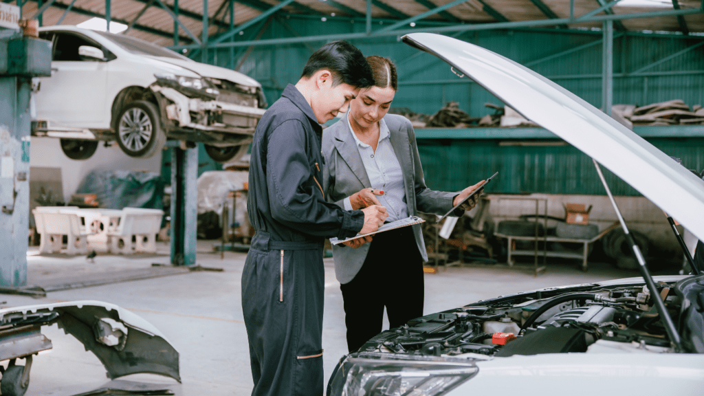 a person standing next to a car in a garage