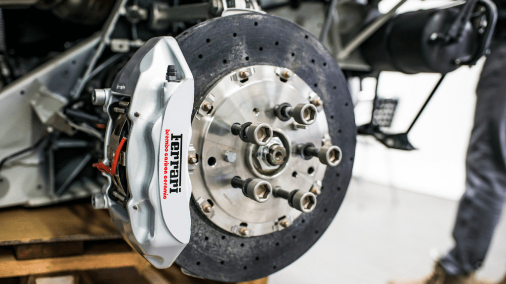 a person is working on the brakes of a car