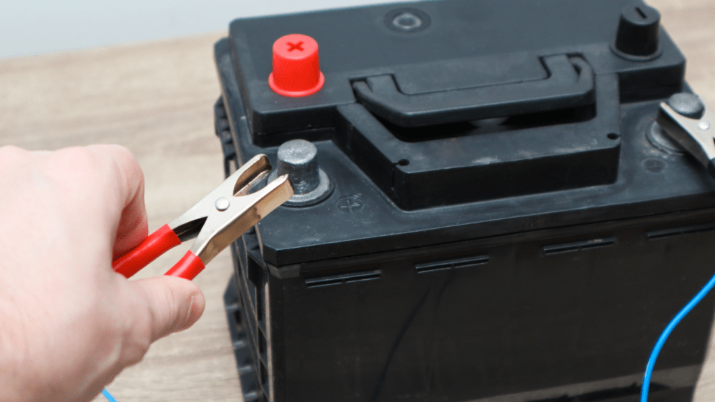 a man holding a car battery