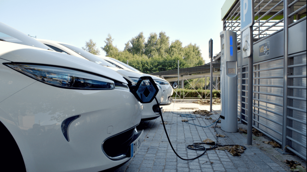 an electric car is plugged into an electric charging station