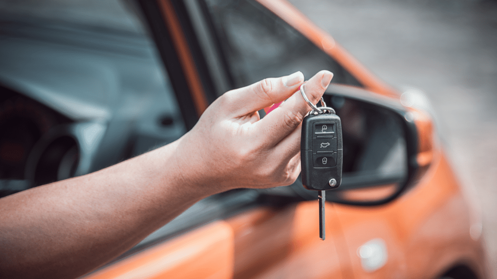 a person is holding a key to a car