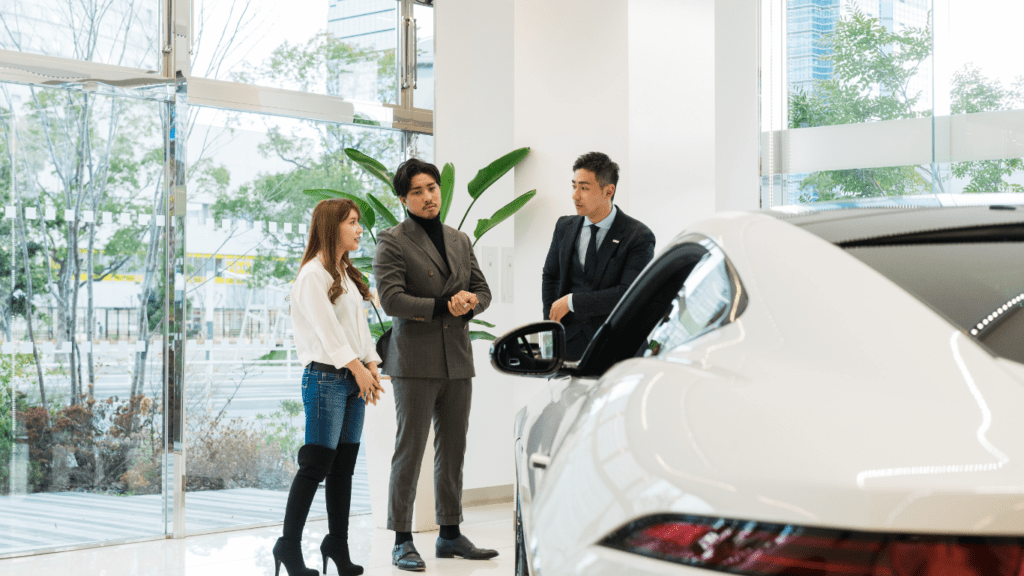 a group of people looking at a car