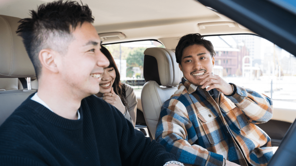 a group of people driving a white car