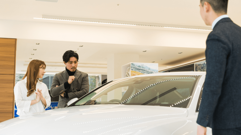 a group of people looking at a car