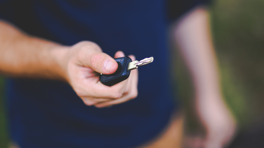 a man holding car key