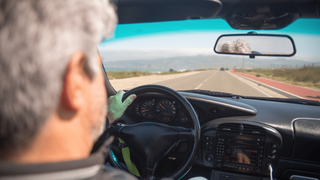 a person driving a black car