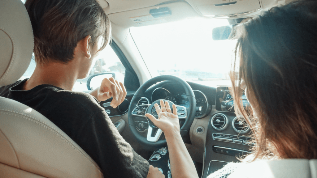 a person driving in a car with mountains in the background