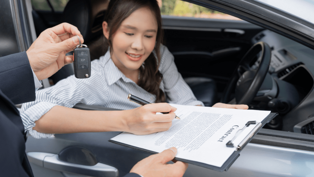 a person is sitting in the driver's seat of a car and holding a clipboard