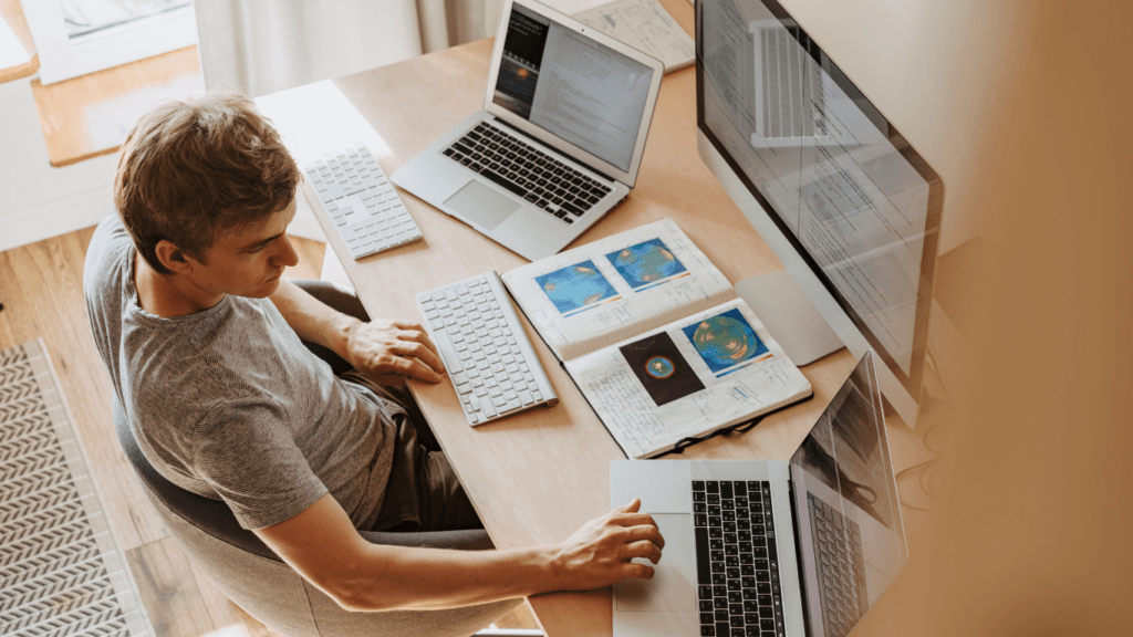 a person looking at a laptop screen with a stock chart on it