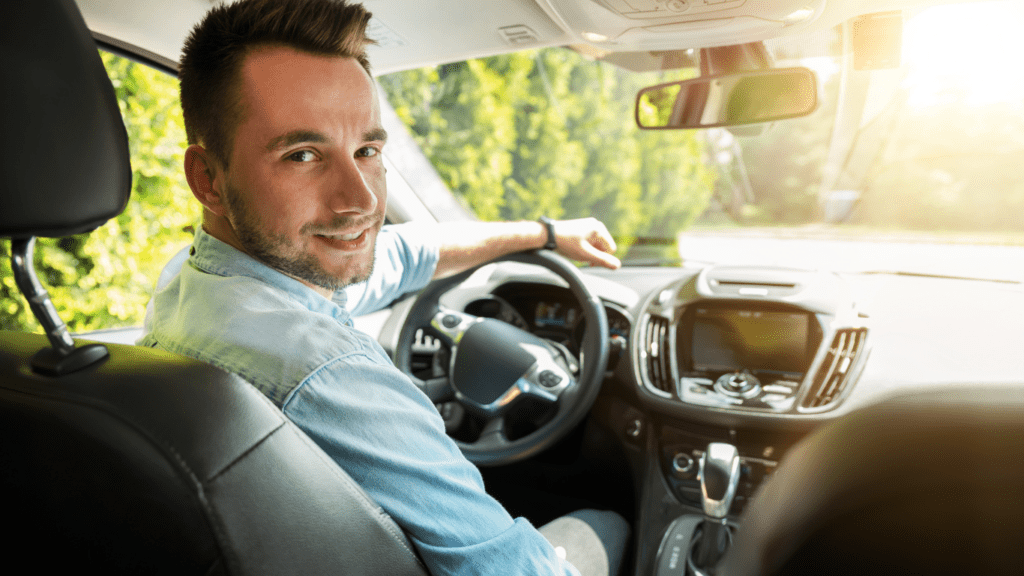 a person sitting in the driver's seat of a car