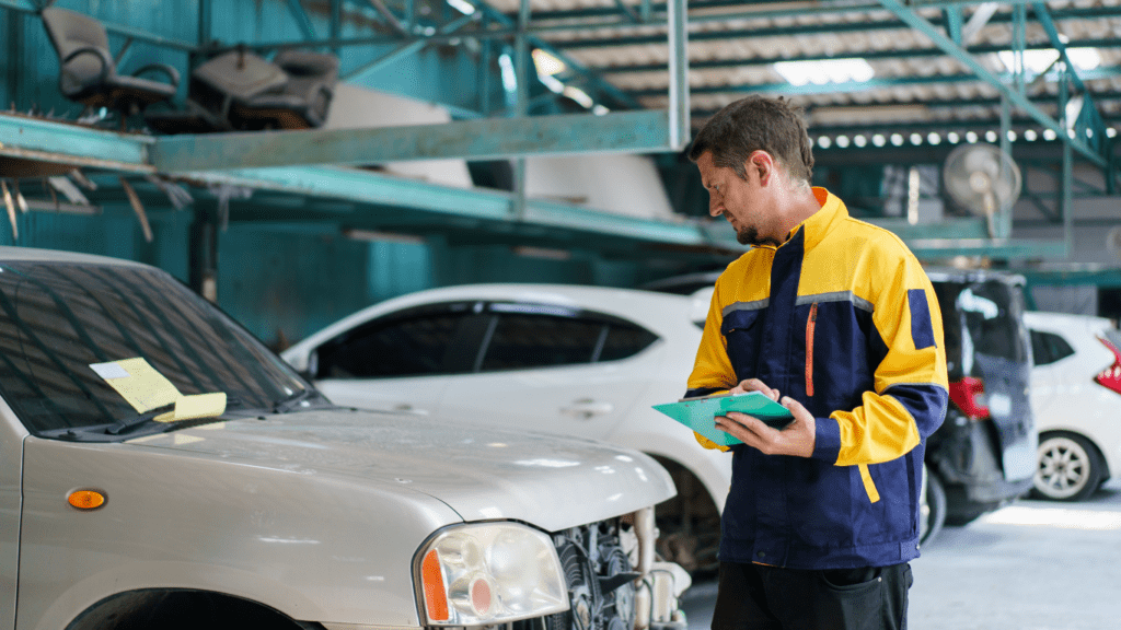 a person standing next to a car in a garage