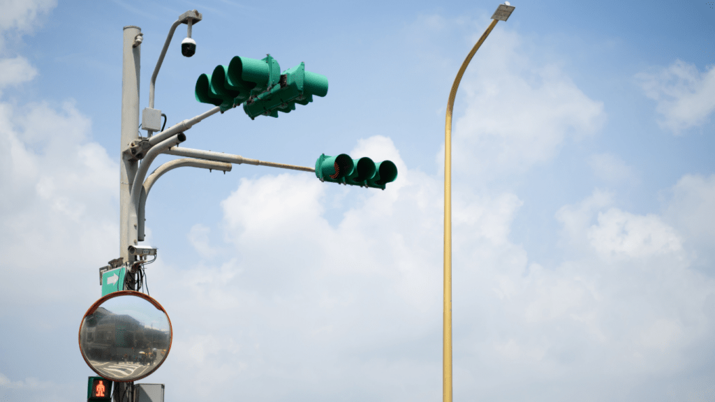 an empty street with traffic lights and an overpass