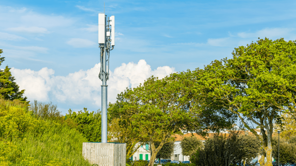 three cell phone towers against a blue sky